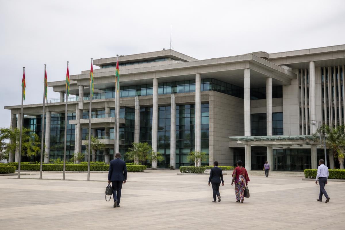 Officials walking across the forecourt of a government ministry building