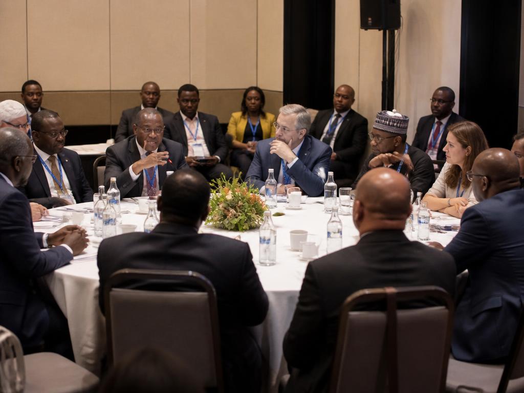 Delegates seated around a roundtable at a formal convening