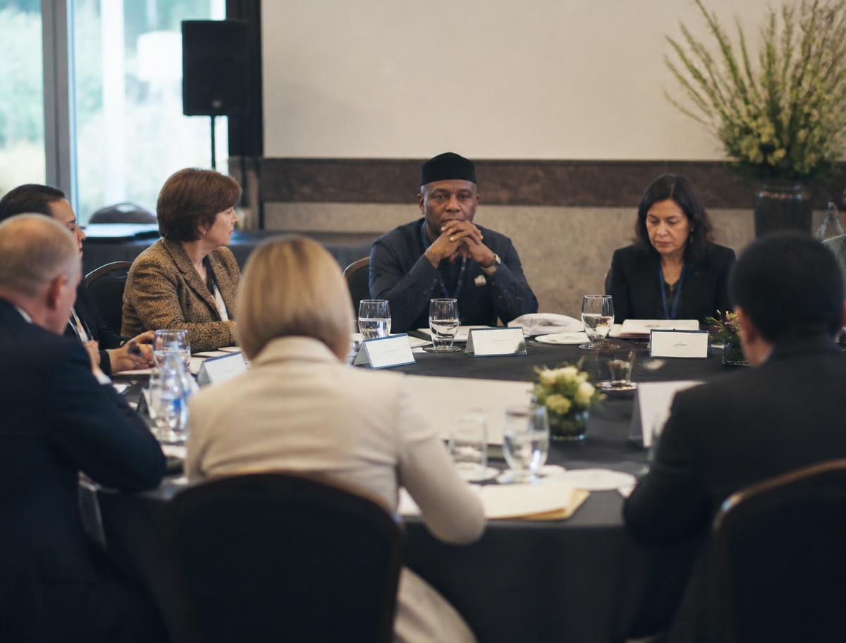 Delegates seated around a roundtable at a formal convening